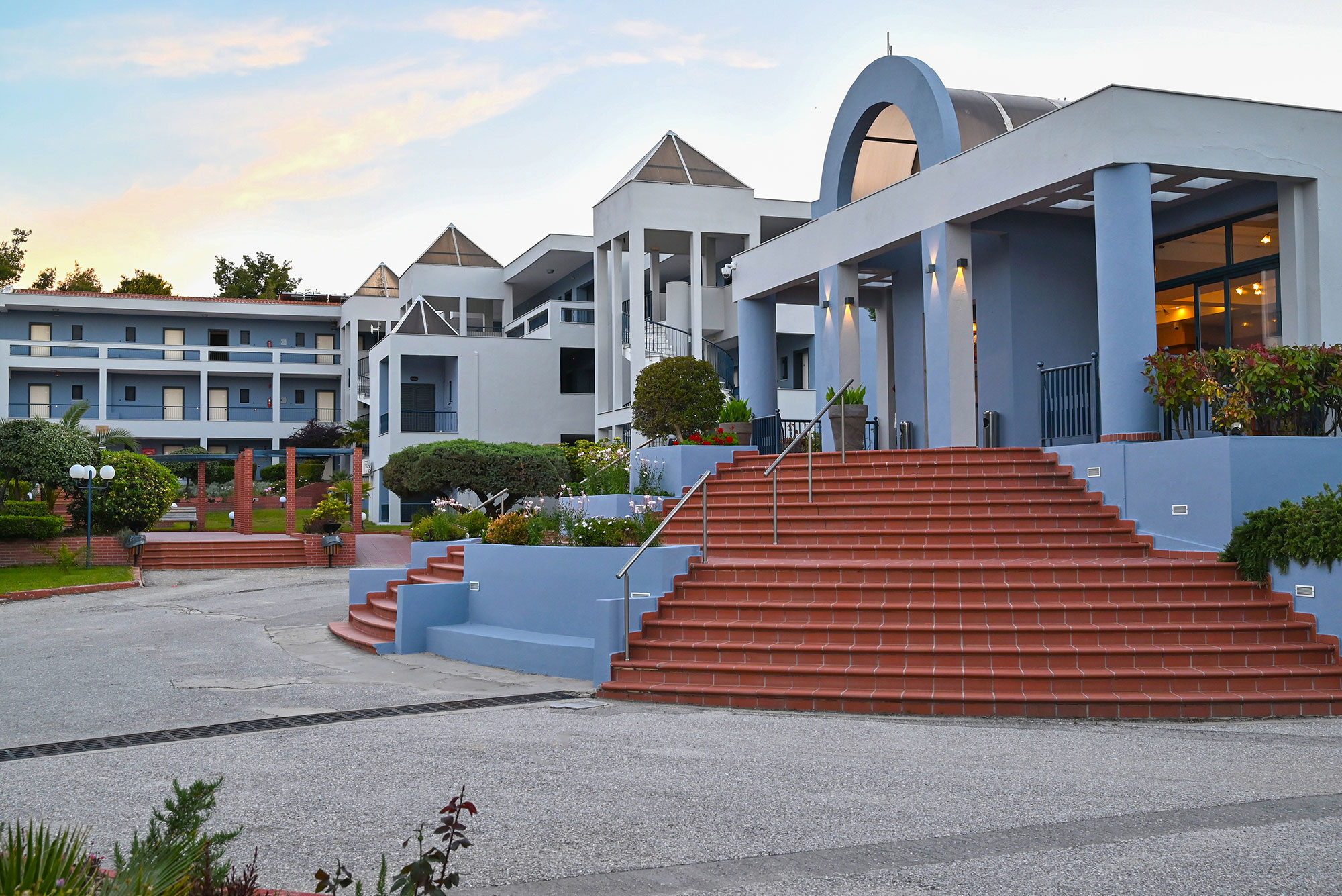 Atrium Hotel entrance drive with the blue buildings and terracotta steps