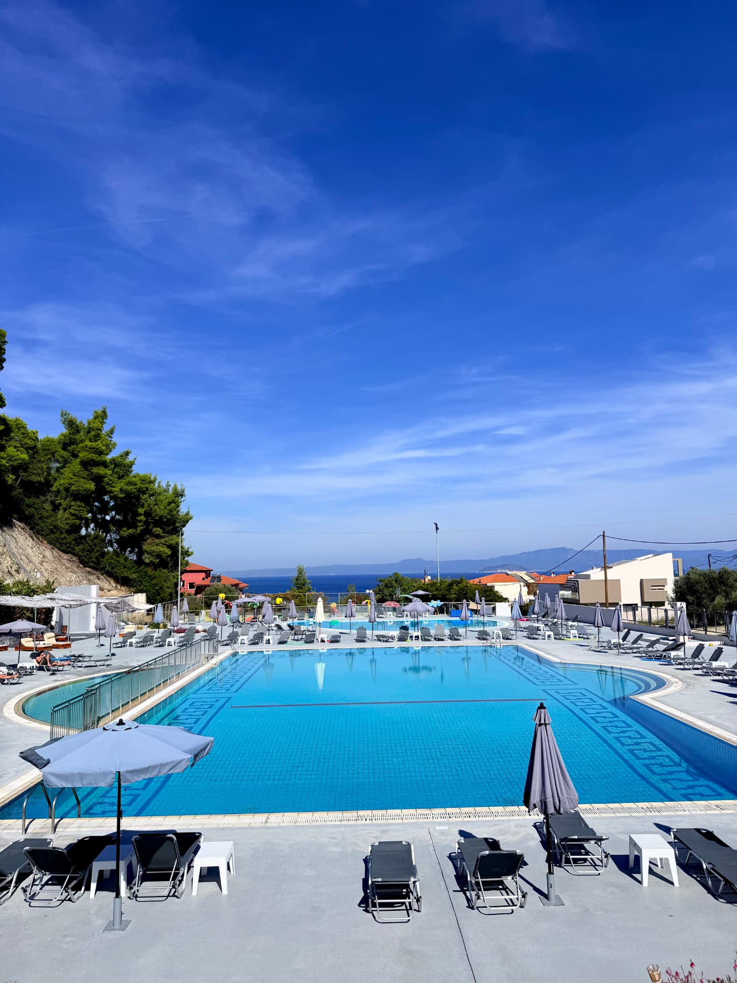 Outdoor swimming pool with the sea in the background